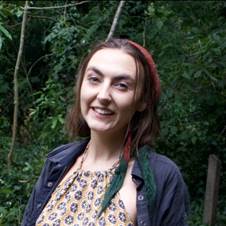 A person smiling at the camera  Description automatically generated