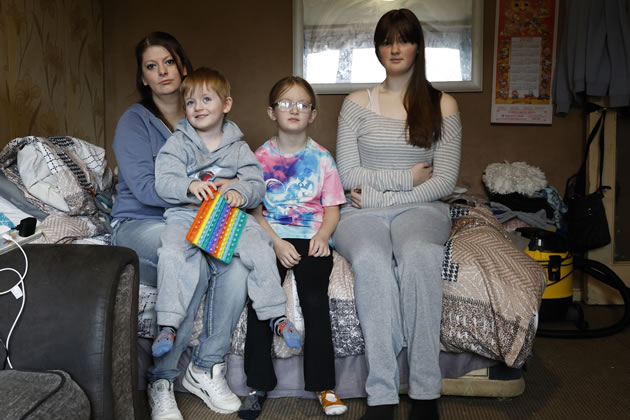 Stacey Watson holding Hunter, 4, next to Bella, 8, and Leona, 14 