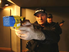 Policeman with taser gun